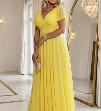 562-8 NASTIA ilga suknelė su iškirpte, raišteliu ir trumpomis rankovėmis – citrininė Limoncello